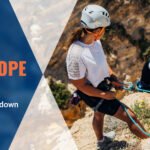 The climbers are standing on a rock by holding the ropes, analyzing the rope strength