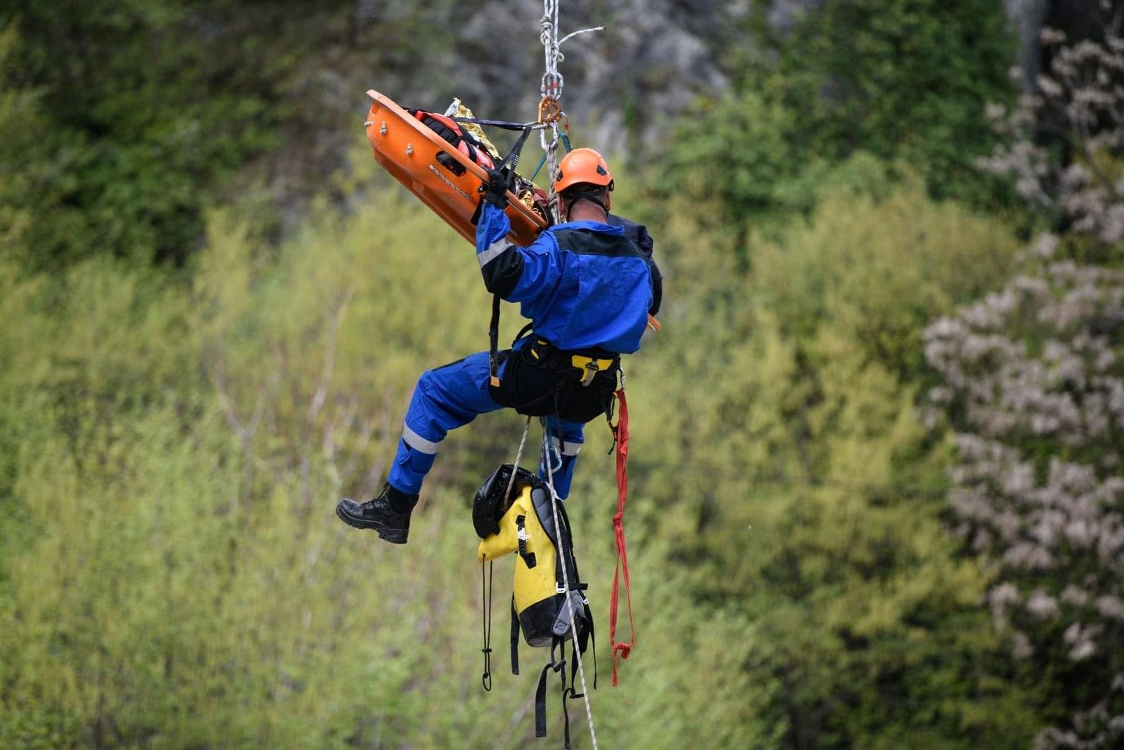 A Man Is Hanging With The Help Of Ropes To Rescue